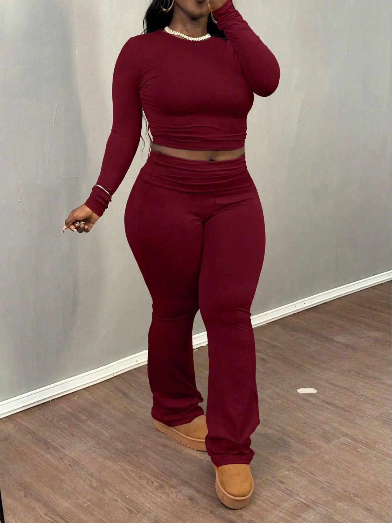 A Wine Red Long-sleeved Crop Top and Flared Pants Collection for Women - A Fashionable and Comfortable Sportswear Set for Ladies
