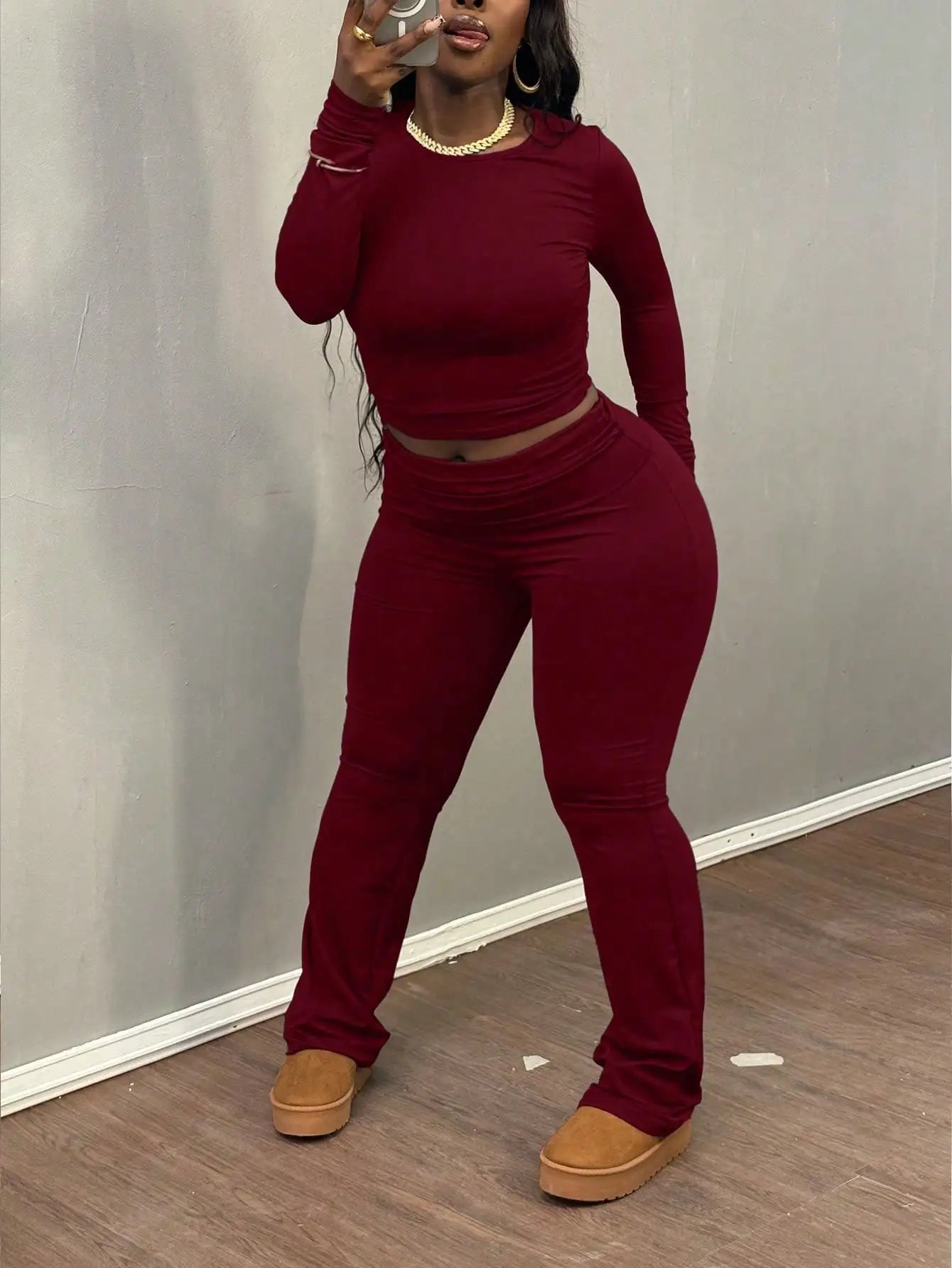 A Wine Red Long-sleeved Crop Top and Flared Pants Collection for Women - A Fashionable and Comfortable Sportswear Set for Ladies