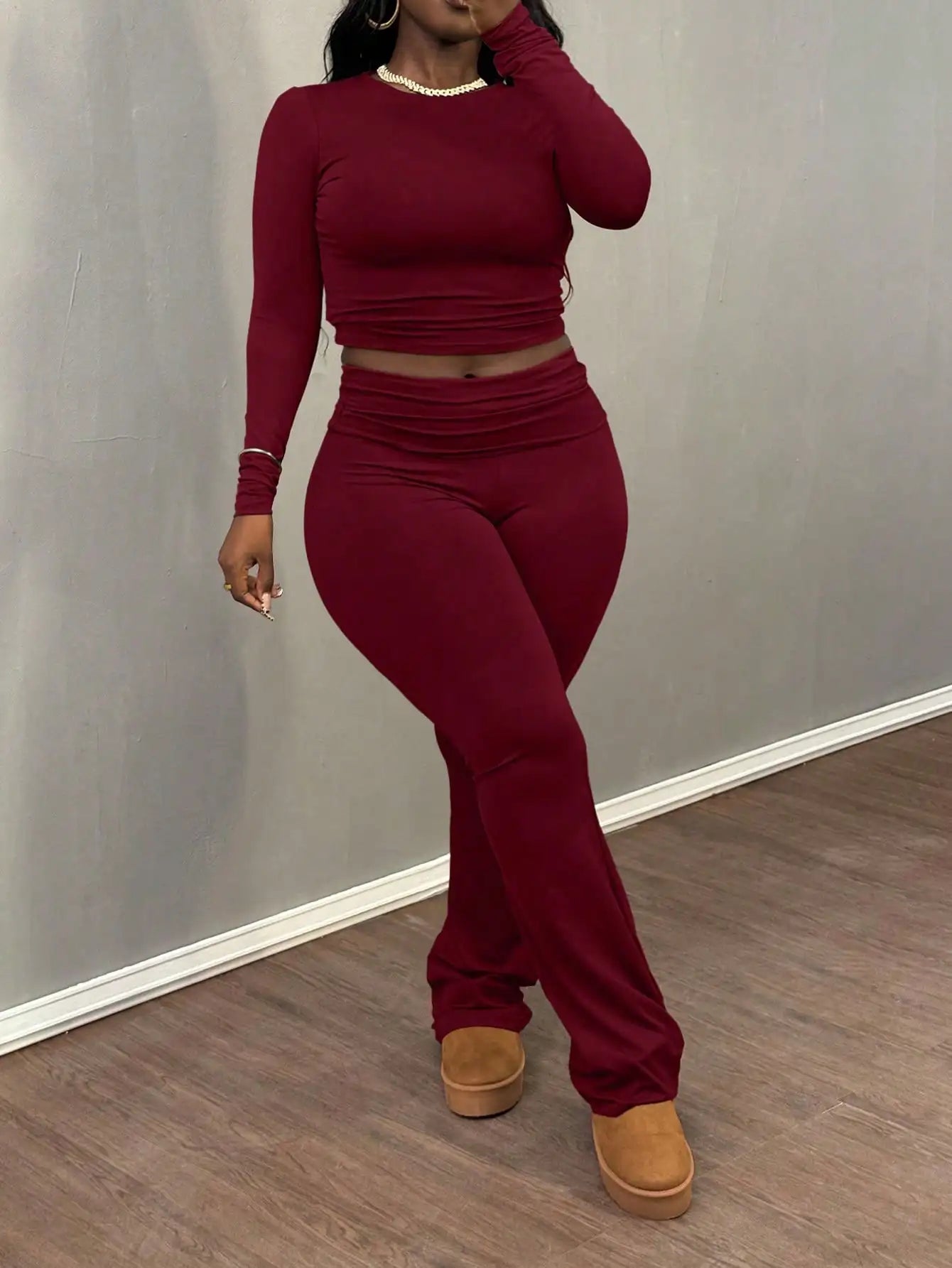 A Wine Red Long-sleeved Crop Top and Flared Pants Collection for Women - A Fashionable and Comfortable Sportswear Set for Ladies